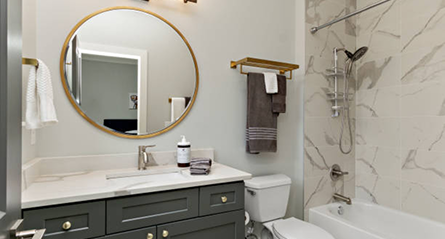 Contemporary hallway leading to a bathroom, with neutral tones and minimalist decor.